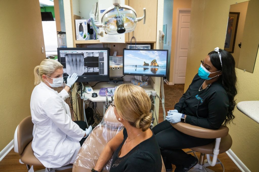 a dentist reviewing x-rays with a patient