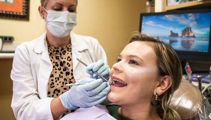 a dentist working on a patients teeth