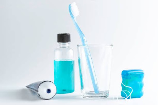 Dental equipment like tooth paste, tooth brush, blue mouth wash